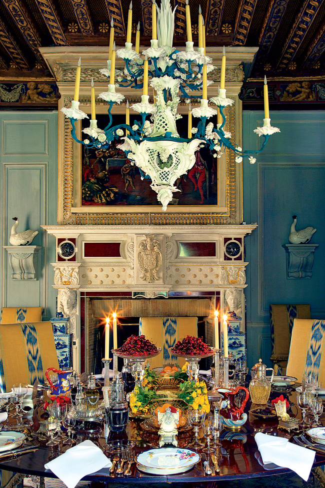 Wideville. A painted t?le and porcelain eighteen-branch composition chandelier, Meissen, 19th century and later, hangs above a table set with a pair of French silver-gilt asparagus dishes and stands, by G. Keller, Paris, late 19th century; pair of cut-glass tazze with Faberg? mark below the imperial warrant, ca. 1885